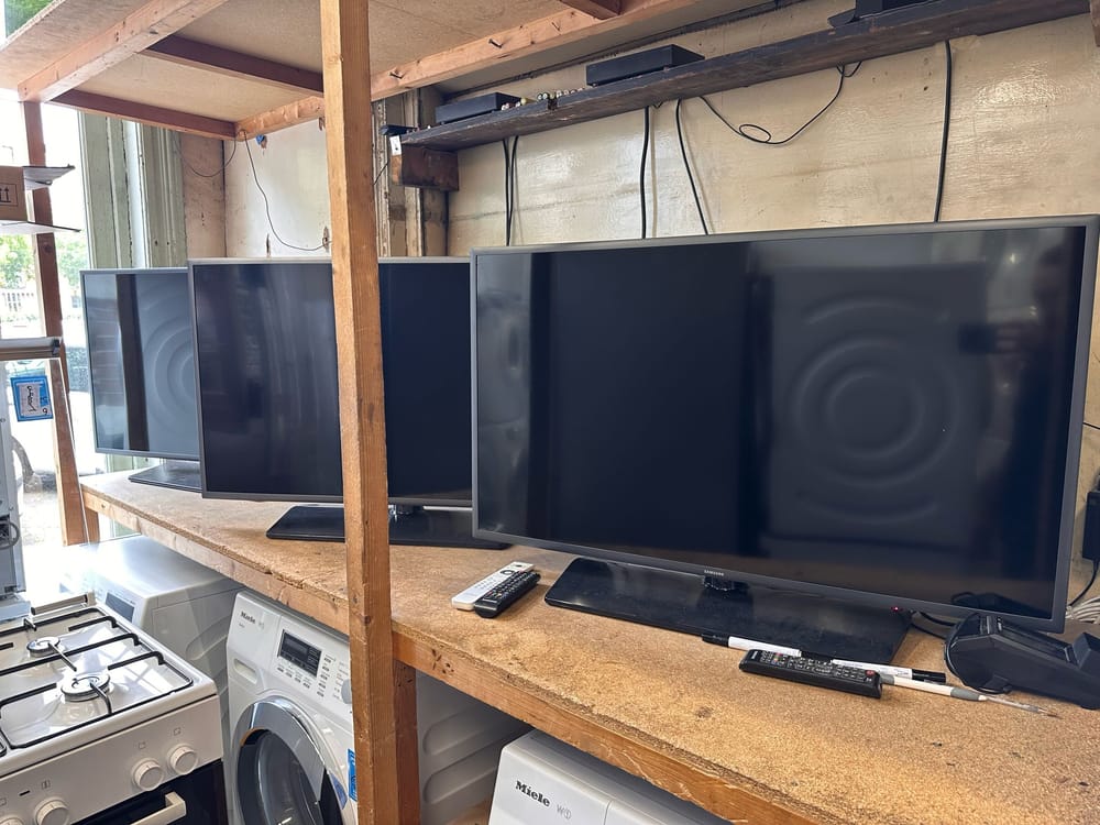 Tweedehands televisies op een schap in de winkel